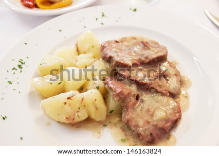 DIsh of meat with potatoes and oil sauce