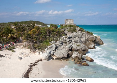 TULUM, MEXICO - MAY 18, 2013: tourists visiting the mayan ruins in a sunny day. The ruins are situated along the east coast of the Yucatan Peninsula in the state of Quintana Roo, Mexico.