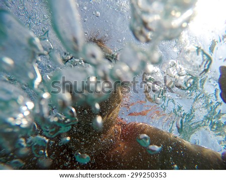 Swimming under the water with bubbles