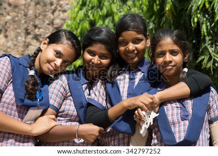 DELHI, INDIA - OCTOBER 11, 2015: unidentified local school girls for tour in Qutub Minar complex, Delhi, India, as part of national education. The girls in school uniform have fun posing for a photo.