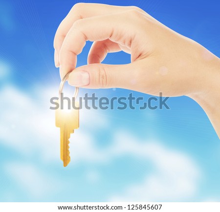 hand holds a gold key
