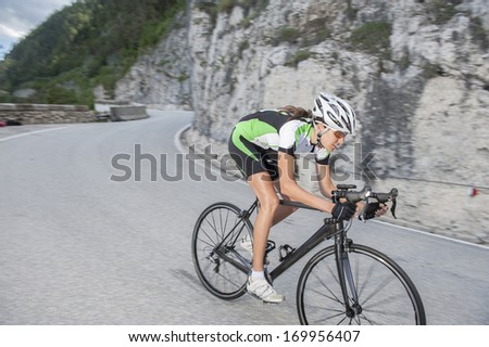 girl by downhill with road cycle - blurred motion