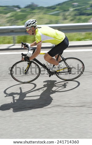 race biker by road cycling downhill - portrait format