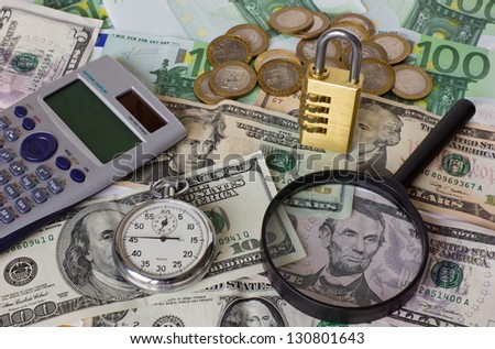 calculator, watch,  lock and magnifier against dollar and euro