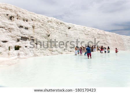 PAMUKKALE, TURKEY - MAY, 31: Tourists on Pamukkale travertines on May 31, 2013 in Pamukkale, Turkey. Pamukkale, UNESCO world heritage site, nowadays become one of the most visited sight in Turkey