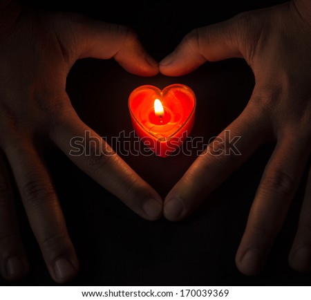 burning heart in heart hands.