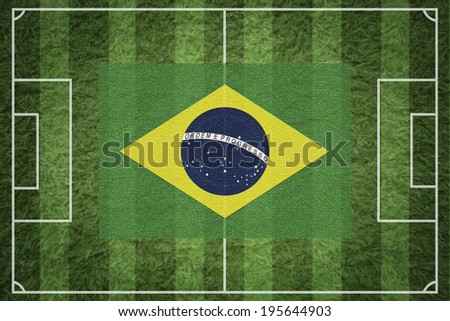 Brazil flag on green soccer field or football field.