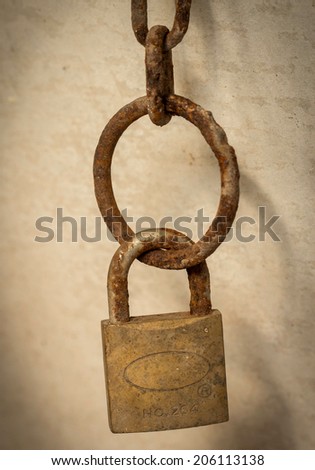 close up of rusty old chain with key lock