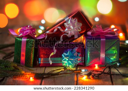 Set of Christmas gift boxes with light on wood.