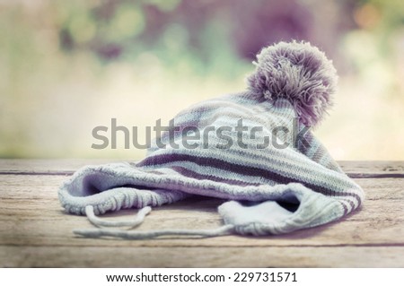 knitted wool hat isolated on wood