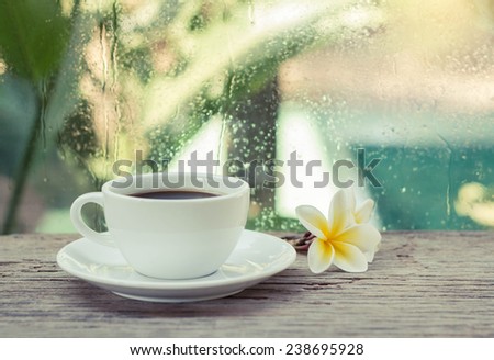 Cup of coffee with flower in the morning.