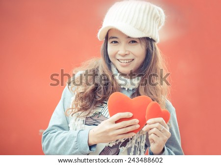 Happy women with red hearts,valentines day background.