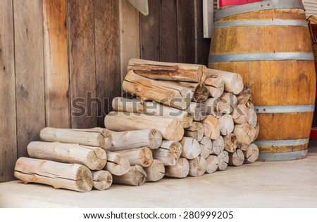 stack of firewood logs in front of a hut.