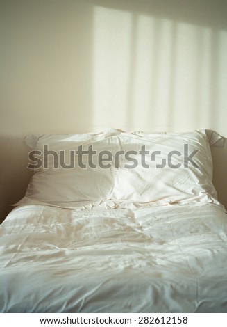 White themed bed sheets and pillow messed up in the morning