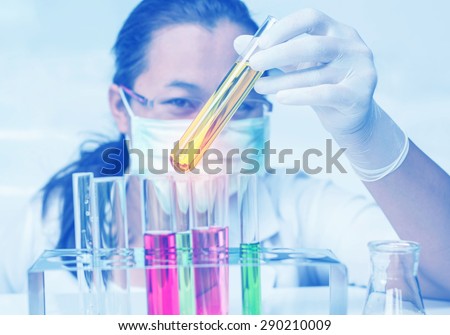 Medical or scientific researcher with flask making test or research in clinical laboratory