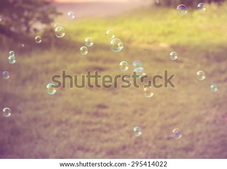 Rainbow bubbles from the bubble blower,vintage background.