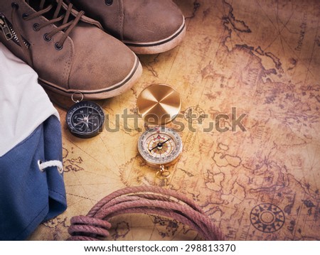compass on vintage map with accessory to the Adventure.