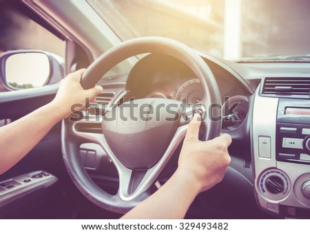 Woman driving car with vintage filter.