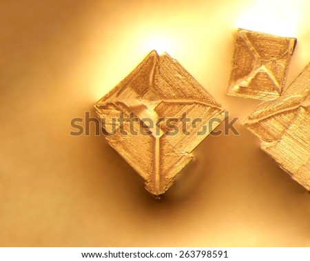 Photographic image of microscopic table salt crystals illuminated by incandescent light and magnified 25x