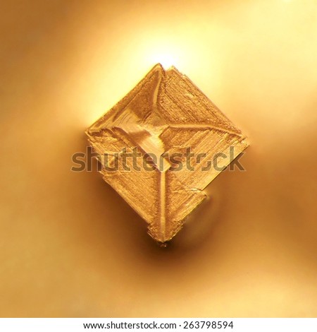 Photographic image of a microscopic table salt crystal illuminated by incandescent light and magnified 25x