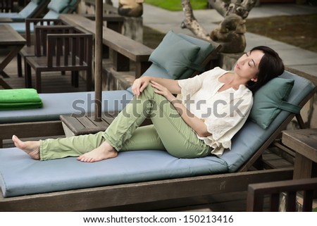 Woman resting on veranda, relaxation outdoors, luxury resort, pleasure concept