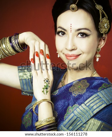 Asian woman in traditional clothing with bridal makeup and jewelry. posing