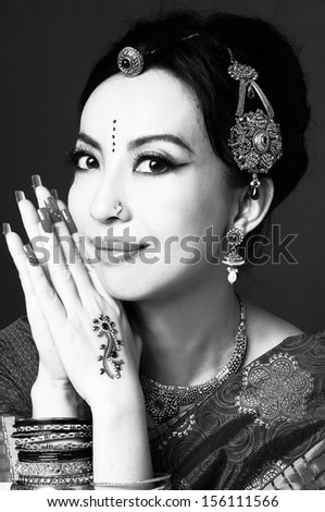 asian woman in traditional clothing with bridal makeup and jewelry shot black and whit
