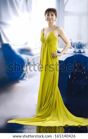 Full body beautiful woman wearing yellow wedding dress posing
