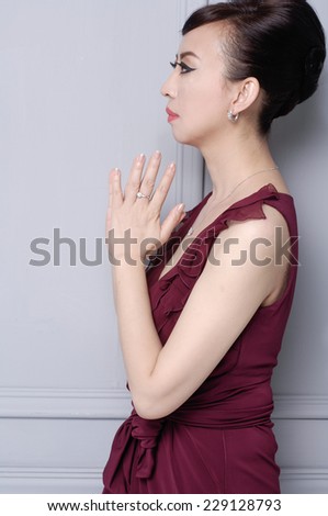 woman wearing red cocktail dress in studio