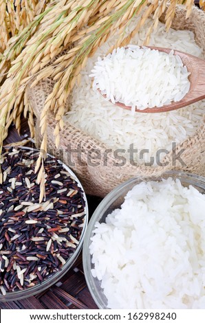 Raw rice, Selection Of black rice white rice and white steamed rice with wood spoon .