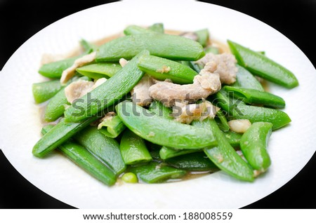 Mixed cooked vegetables with pork on white plate
