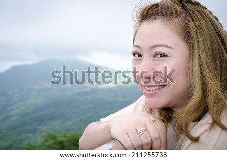 Asian woman smiling natural candid in happy outdoor portrait. In North thailand, PETCHABOON, THAILAND .