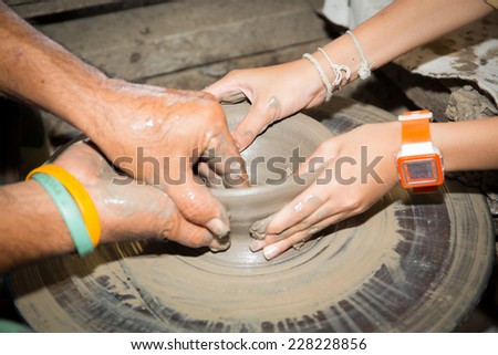 close up of Asian child hands and potter hand craft is training