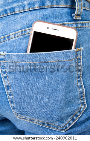 Smart phone in back pocket of girl\'s jeans .