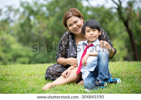 Happy Asian family ,mother with her son at park
