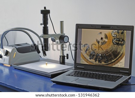 High-tech car service laboratory with digital microscope.