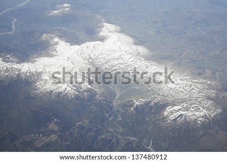 Aerial view of snowy mountains, picture from plane.