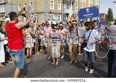 SZCZECIN, POLAND - AUGUST 4th: Crew Parade during the Final of The Tall Ships Races 2013 in Szczecin, the crews of the tall ships with street artists paraded through the streets of Szczecin, Poland.
