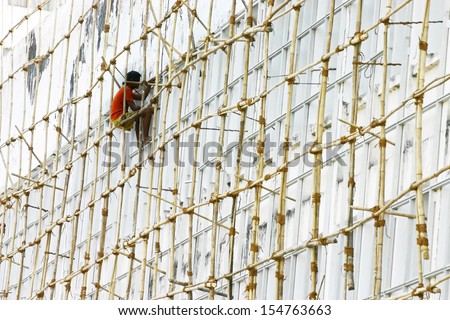 Worker on the bamboo scaffold.