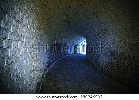 Old desolated tunnel with blue glowing effect, HDR processing.