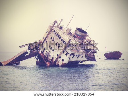 The sunken shipwreck on the reef, Egypt, vintage retro filtered.