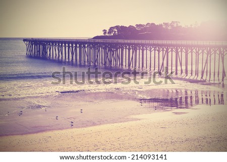 Vintage wood bridge at beach sunset, California, USA.