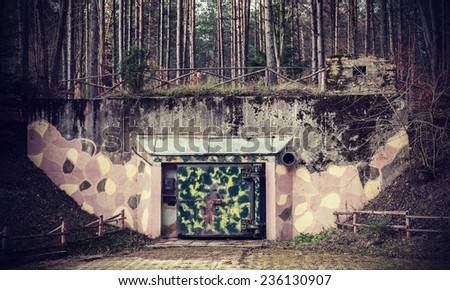 Retro filtered picture of a bunker in forest.