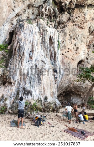RAILAY, THAILAND - DECEMBER 31, 2014: Rock climbers and tourists on Railay beach, one of the most popular rock climbing locations in Asia.