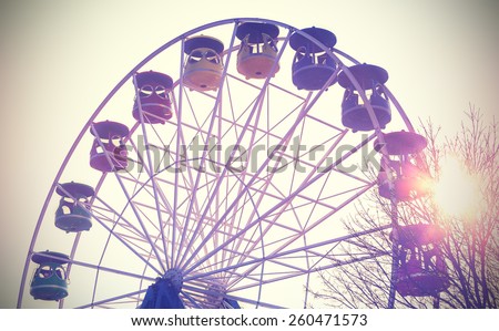 Retro vintage filtered picture of a carousel at sunset, concept background.