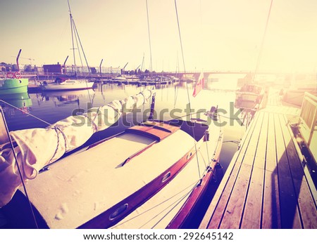 Vintage instagram stylized sailing boats at sunrise.
