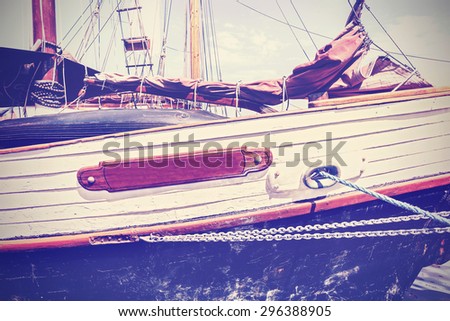 Vintage toned boat side, nautical background.