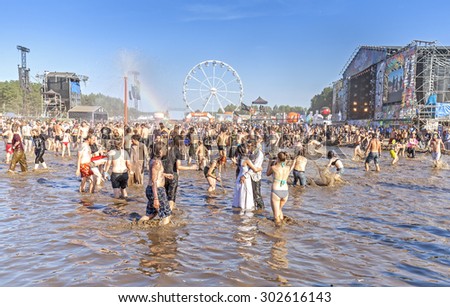 KOSTRZYN NAD ODRA, POLAND - AUGUST 1, 2015: People playing in mud during 21th Woodstock Festival Poland (Przystanek Woodstock), one of the biggest open air festival\'s in Europe.