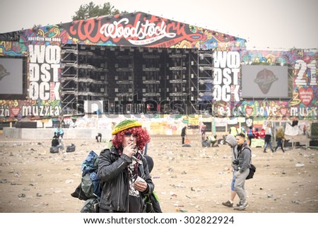 KOSTRZYN NAD ODRA, POLAND - AUGUST 1, 2015: Woodstock fan standing in front of main stage on the 21th Woodstock Festival Poland, one of the biggest open air festivals in Europe.