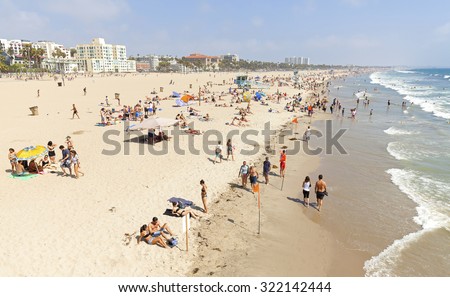 LOS ANGELES, USA - AUGUST 22, 2015: People resting on the Venice Beach during peak season. Venice was an independent city until 1926, when it merged with Los Angeles.